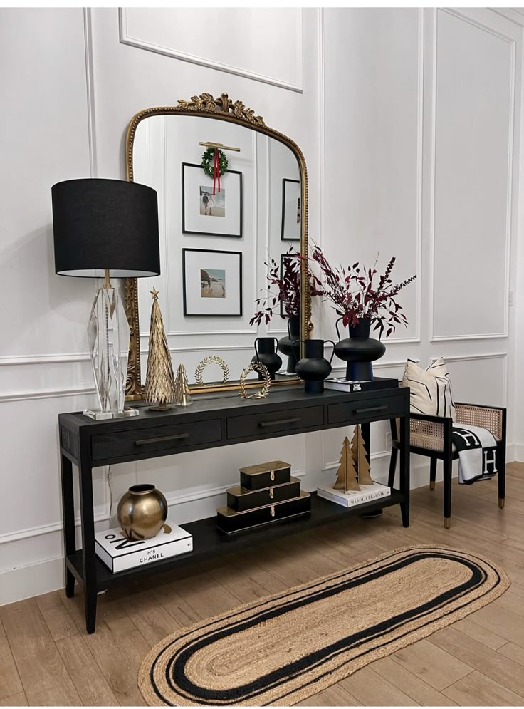 pairing a vintage jharokha mirror with an industrial console table for edge in black and white with vintage gold accents