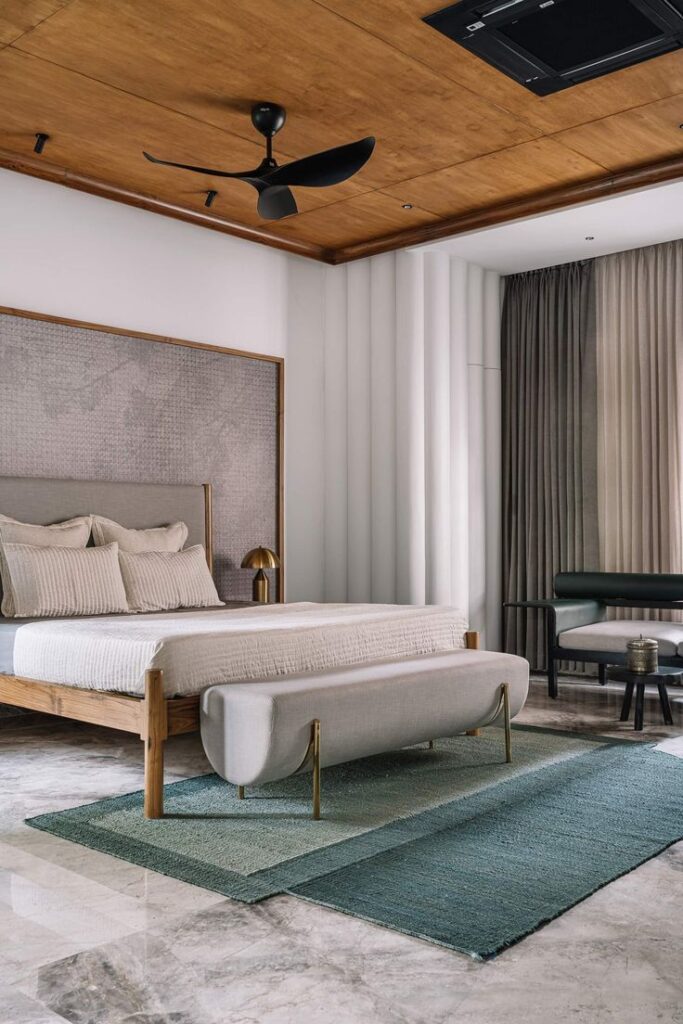 Bedroom interior design with monochrome palettes infused with rich textures, finished with accent rugs and wood ceiling