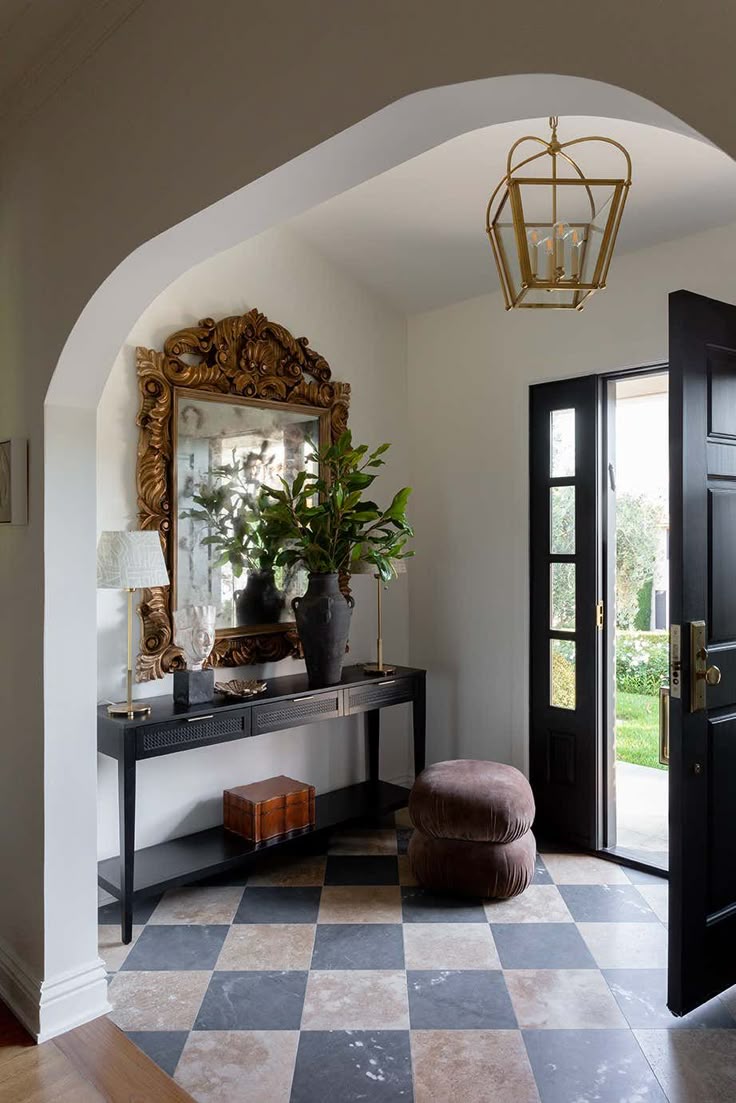 pairing a vintage jharokha mirror with an industrial console table with lush plants